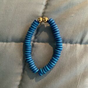Cute dark blue and light blue clay bracelet with two gold beads